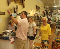 Kim McAbee, and her mother, Nancy, serve customers at the store on Friday,
 